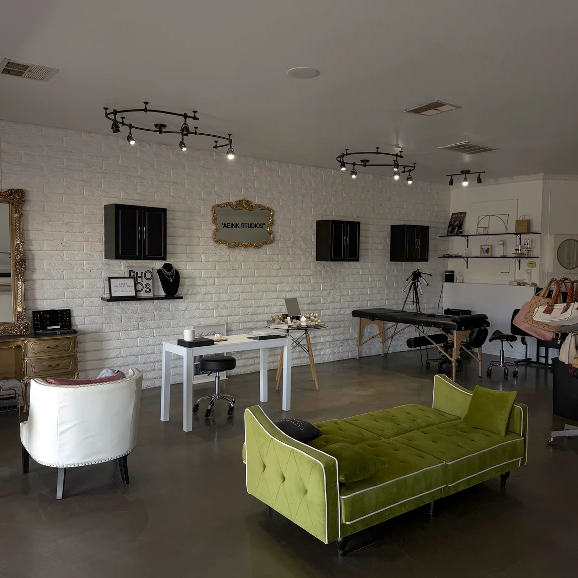 The studio lounge, with a green velvet daybed and vintage seating.